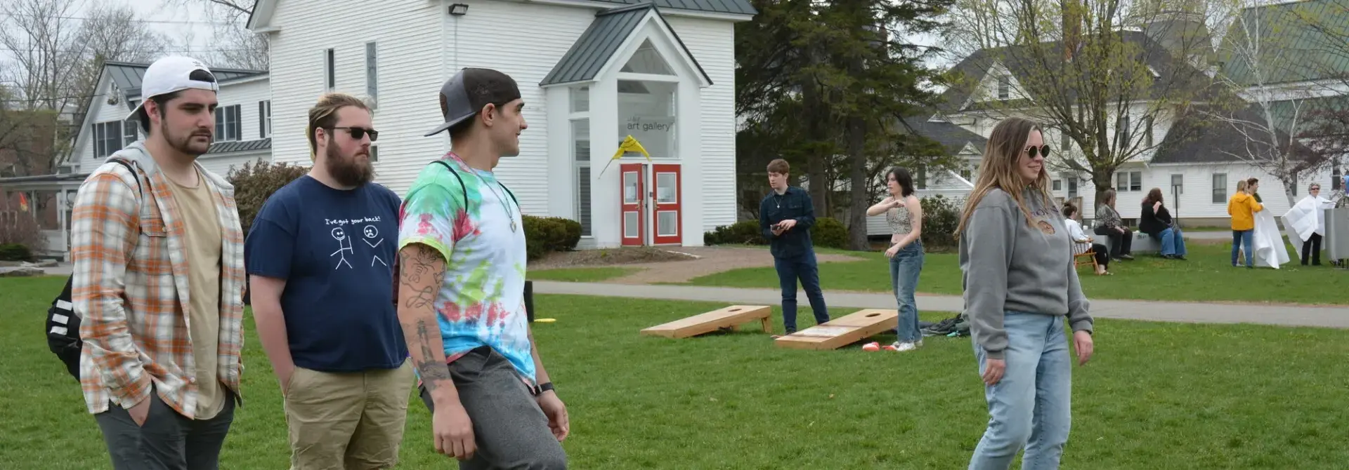 Farmington students play soccer on campus greenery.