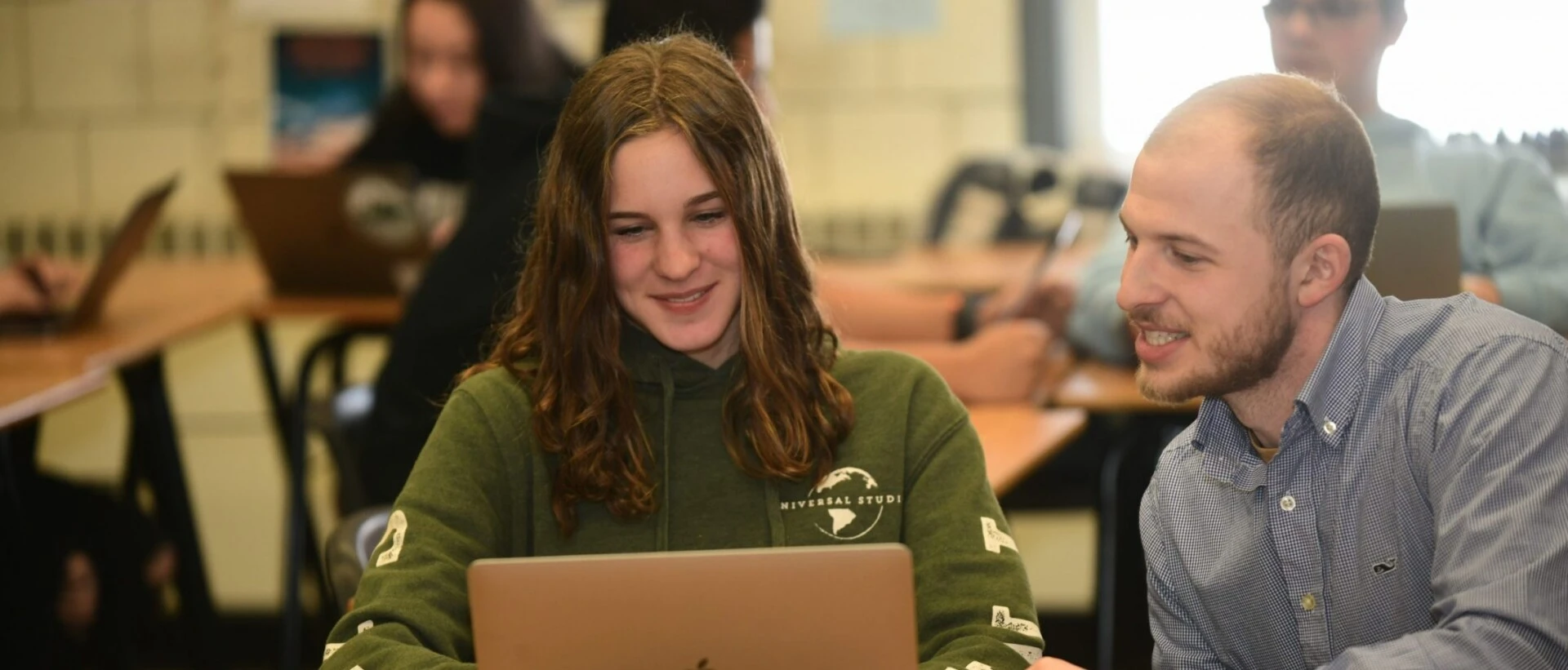 Inclusive Special Education and Leadership students work together at computer.