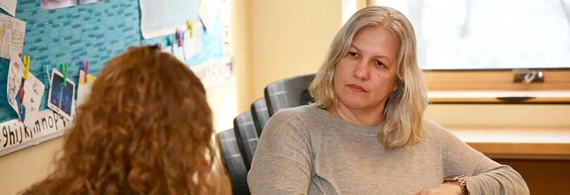 Systems of Student Support students sit in classroom and discuss.